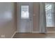 Entryway features a decorative glass front door, wood flooring, and adjacent window with blinds at 2868 S 525 W, Trafalgar, IN 46181