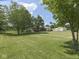 Wide view of the home, garage, barn, and trees on a spacious lawn at 2868 S 525 W, Trafalgar, IN 46181