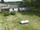 Ranch-style home features a well-maintained lawn, mature trees, and an enclosed porch for outdoor living at 2868 S 525 W, Trafalgar, IN 46181