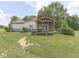 Exterior rear view of the home showcasing the lawn, porch and landscaping at 2868 S 525 W, Trafalgar, IN 46181
