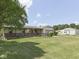 Home with a covered front porch, attached garage, outbuilding, and green lawn at 2868 S 525 W, Trafalgar, IN 46181
