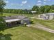 Aerial view of a home, garage, barn, pasture, and fencing on a sunny day at 2868 S 525 W, Trafalgar, IN 46181
