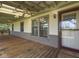View of a covered front porch with a ceiling fan, brick accent, and the front door at 2868 S 525 W, Trafalgar, IN 46181