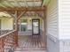 A view of the covered front porch of the home, with a ceiling fan and painted brick at 2868 S 525 W, Trafalgar, IN 46181