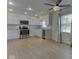 Bright kitchen features white cabinets, stainless steel appliances, tile backsplash, and wood floors at 2868 S 525 W, Trafalgar, IN 46181