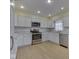 Updated kitchen with stainless steel appliances, marble countertops, and white cabinets at 2868 S 525 W, Trafalgar, IN 46181