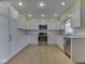 Modern kitchen features white cabinets, stainless steel appliances, and stone countertops at 2868 S 525 W, Trafalgar, IN 46181