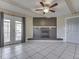 Living room shows brick fireplace, beamed ceiling, tile floors, and glass doors to outside at 2868 S 525 W, Trafalgar, IN 46181