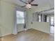 Bright living room with wood flooring, ceiling fan, and large window provides natural light at 2868 S 525 W, Trafalgar, IN 46181