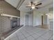 Living room featuring brick fireplace, tile floors, beamed ceiling, and access to the kitchen at 2868 S 525 W, Trafalgar, IN 46181