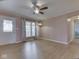 Living room with neutral paint, hardwood floors, ceiling fan, and front door access at 2868 S 525 W, Trafalgar, IN 46181