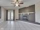Living room has brick fireplace, beamed ceiling, tile floors, and sliding glass doors to outside at 2868 S 525 W, Trafalgar, IN 46181