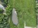 Aerial shot of a tranquil pond surrounded by lush greenery, enhancing the property's natural appeal at 2868 S 525 W, Trafalgar, IN 46181