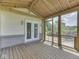 Enclosed sunroom with wood floors, brick accents, and a view of the green landscape at 2868 S 525 W, Trafalgar, IN 46181