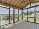 Enclosed sunroom featuring tongue and groove ceiling and wood flooring offers views of the backyard at 2868 S 525 W, Trafalgar, IN 46181