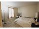 Bright bedroom boasts wood-look flooring, complemented by curtains, vanity, and neutral walls at 291 Lakemoore St, Brownsburg, IN 46112