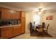 Bright kitchen nook area features wood cabinets, a tile floor, and a modern glass dining table at 291 Lakemoore St, Brownsburg, IN 46112