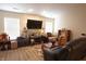 Inviting living room featuring wood floors, large TV, and comfortable seating area at 291 Lakemoore St, Brownsburg, IN 46112