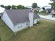 Well-maintained home with a brown roof, light siding, and a lush lawn with mature trees at 291 Lakemoore St, Brownsburg, IN 46112