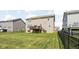 Backyard view showcasing a raised deck and ample green space surrounded by a sleek black fence at 3969 Canning St, Danville, IN 46122