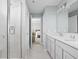 Light-filled bathroom boasts double sinks, quartz countertops, and a tiled walk-in shower at 3969 Canning St, Danville, IN 46122