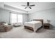 Bright bedroom offers a ceiling fan, plush carpet, a lounge chair, and natural light at 3969 Canning St, Danville, IN 46122