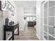 Hallway view with hard surface flooring, console table, and an open view into the living room at 3969 Canning St, Danville, IN 46122
