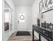 Welcoming entryway with wood floors, decorative console table, and a charming 'Welcome' sign at 3969 Canning St, Danville, IN 46122