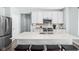 Bright kitchen featuring white cabinetry, a large center island with seating, and modern appliances at 3969 Canning St, Danville, IN 46122