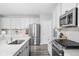 Modern kitchen featuring stainless steel appliances, white cabinets, and a spacious quartz countertop island at 3969 Canning St, Danville, IN 46122