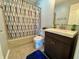Bathroom featuring tile flooring, shower with patterned curtain, and a dark vanity at 4049 Zinfandel Way, Indianapolis, IN 46254