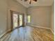 Bright and airy bedroom featuring hardwood floors and sliding glass doors to a deck at 4049 Zinfandel Way, Indianapolis, IN 46254