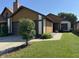 Charming home showcasing a well-maintained lawn, complemented by a lovely tree and a two-car garage at 4049 Zinfandel Way, Indianapolis, IN 46254