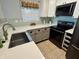 Bright kitchen featuring white cabinets, modern appliances, with backsplash and a stainless steel sink at 4049 Zinfandel Way, Indianapolis, IN 46254