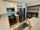 Well-appointed kitchen with white cabinets, stylish backsplash, dark appliances, and nearby laundry area at 4049 Zinfandel Way, Indianapolis, IN 46254