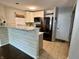 Modern kitchen featuring white cabinets, gray counters, stainless steel appliances, and tile flooring at 4049 Zinfandel Way, Indianapolis, IN 46254