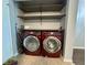 Functional laundry area equipped with modern washer and dryer units plus shelving for supplies at 4049 Zinfandel Way, Indianapolis, IN 46254