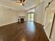 Spacious living room with dark wood flooring, a fireplace, a sliding door and a sliding barn door at 4049 Zinfandel Way, Indianapolis, IN 46254