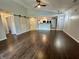Open-concept living room with dark floors flowing into the kitchen area and including a barn door at 4049 Zinfandel Way, Indianapolis, IN 46254