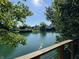 Scenic water view homes, showcasing waterfront living and tranquil community, complete with a wooden deck on a bright sunny day at 4049 Zinfandel Way, Indianapolis, IN 46254