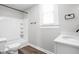 Bathroom with a shower and tub combo, modern fixtures, and a white vanity at 413 E Caven St, Indianapolis, IN 46225