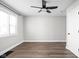 Spacious bedroom with hardwood floors, ceiling fan, closet, and neutral paint at 413 E Caven St, Indianapolis, IN 46225