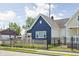 Exterior view of a charming blue home, showcasing its well-maintained yard and inviting curb appeal at 413 E Caven St, Indianapolis, IN 46225