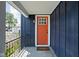 A close-up of a home's entry, showcasing a brightly painted door and stylish exterior lighting at 413 E Caven St, Indianapolis, IN 46225