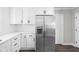 Modern kitchen featuring stainless steel refrigerator, quartz countertops and white cabinets at 413 E Caven St, Indianapolis, IN 46225
