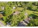 Aerial view of a house surrounded by a large yard, mature trees, and additional buildings on the property at 450 W 250 N, Lebanon, IN 46052