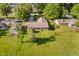 Aerial view of a well-maintained home with a long driveway and large, grassy yard with scattered trees at 450 W 250 N, Lebanon, IN 46052