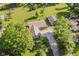 Aerial view of a brick home with a long driveway surrounded by mature trees and a large, well-manicured lawn at 450 W 250 N, Lebanon, IN 46052