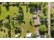 Aerial view of a large grassy lot with mature trees, a home, a pool, and various outbuildings at 450 W 250 N, Lebanon, IN 46052