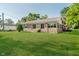 The backyard of this brick home features well-maintained lawn perfect for outdoor activities and relaxation at 450 W 250 N, Lebanon, IN 46052